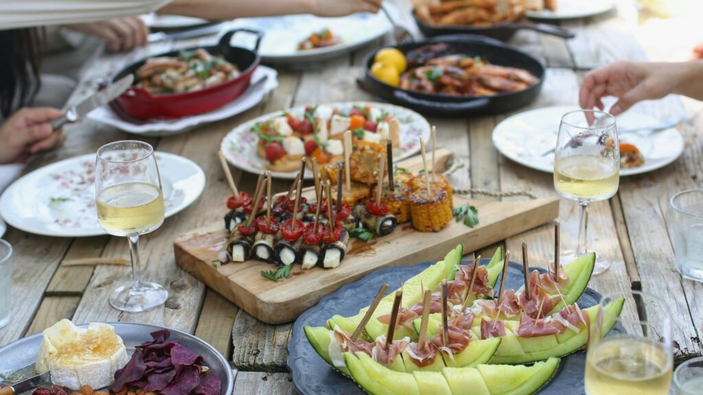 people enjoying a buffet of food al fresco