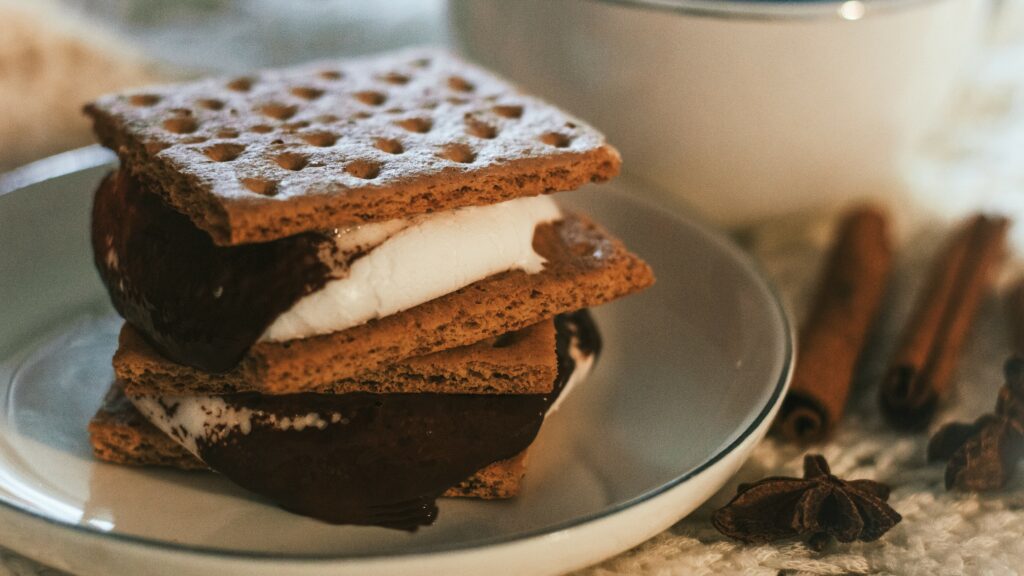 smore plated up next to cinnamon sticks