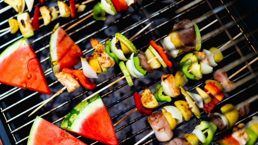 vegetarian skewers and watermelon on a bbq