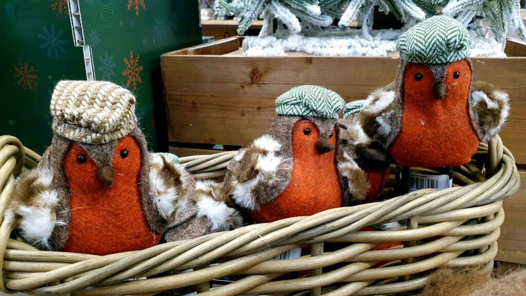 three woodland robin decorations in a basket